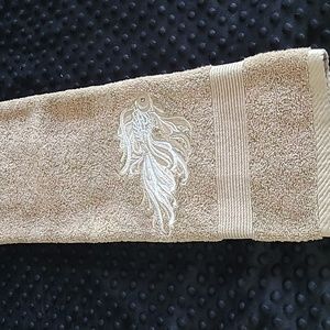 Hand towel tan with a  embroidered  fish